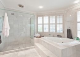 White-themed bathroom with freestanding bath and neutral tiling