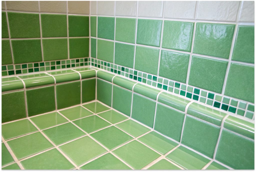 Bathroom corner with white subway tiles and freshly sealed light grout in a Hobart home