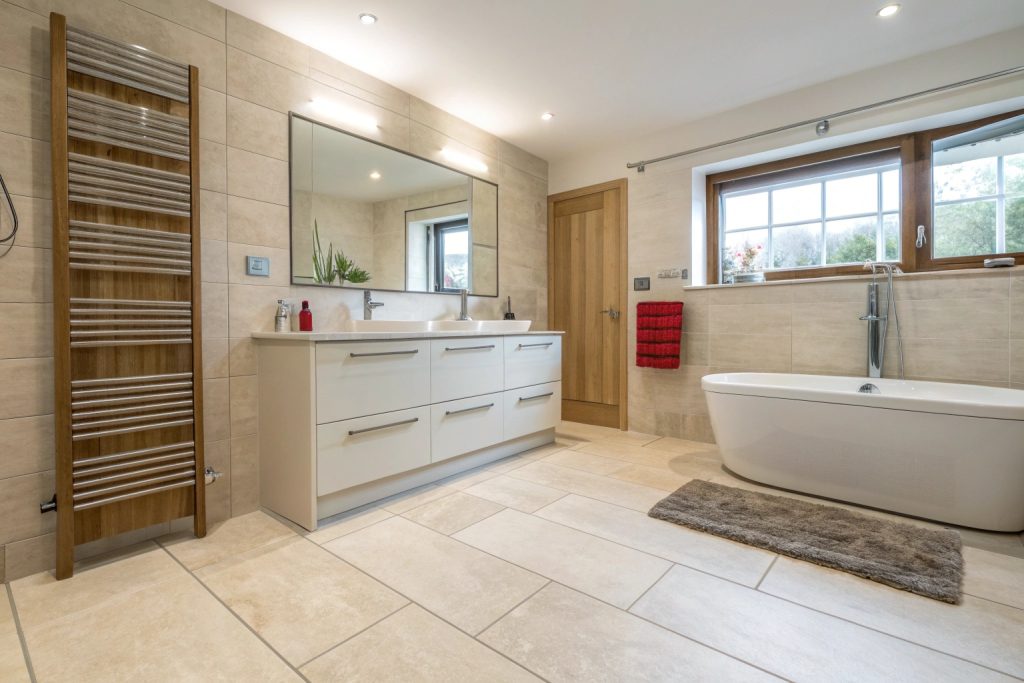 Family bathroom with light-coloured large-format floor tiles in a Hobart home