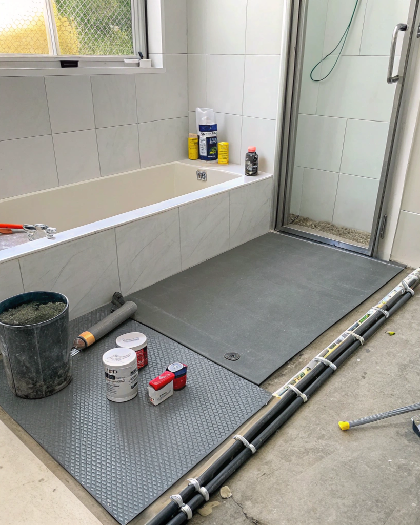 AS 3740 compliant waterproofing membrane applied to a bathroom shower recess before tiling
