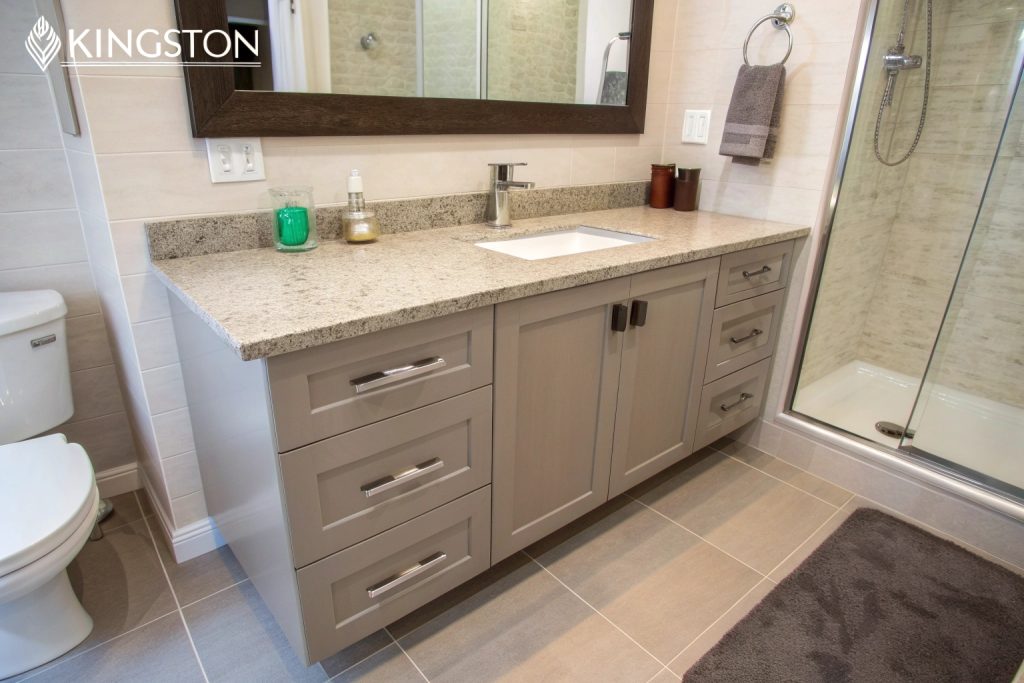 Custom bathroom vanity installation Kingston with stone countertop and storage solutions
