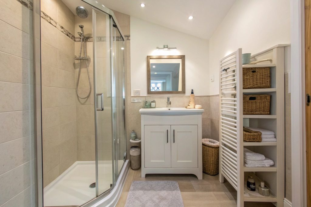 Corner shower and sliding door layout maximising space in a small ensuite
